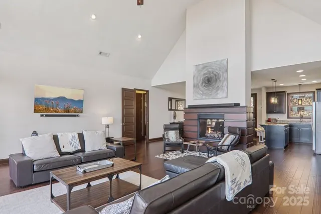 a living room with fireplace furniture and wooden floor