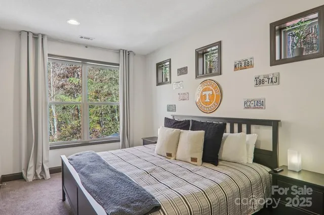 a bedroom with a bed and painting on the wall