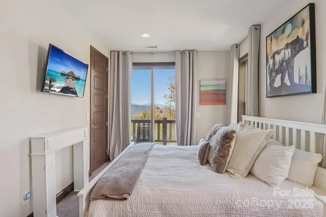 a bedroom with a large bed and a painting on the wall