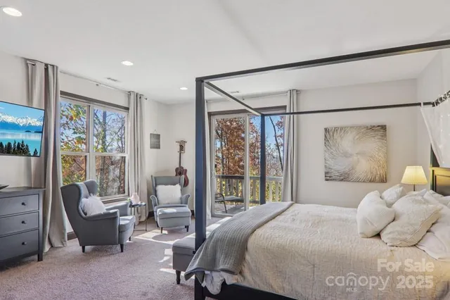 a bedroom with a large bed and a large window