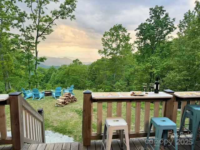 a view of a chairs and table in the deck in front of house