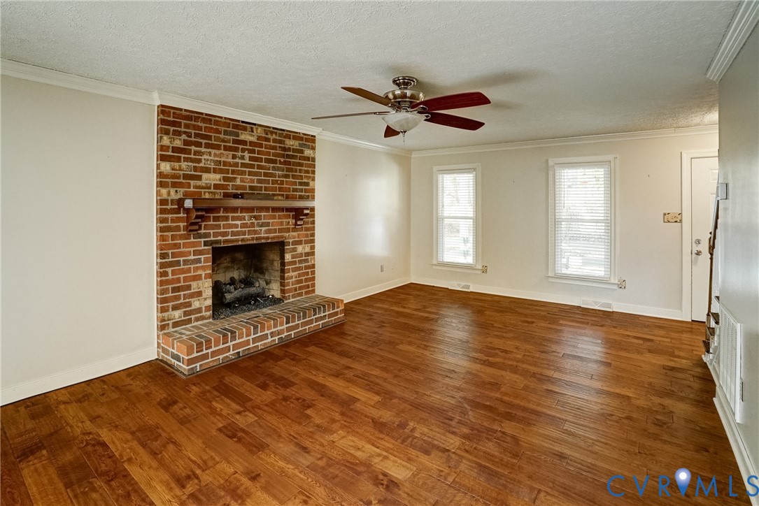 1253 Cardwell Road Crozier, VA 23039 - Photo 18 of 50 a view of empty room with wooden floor and fireplace