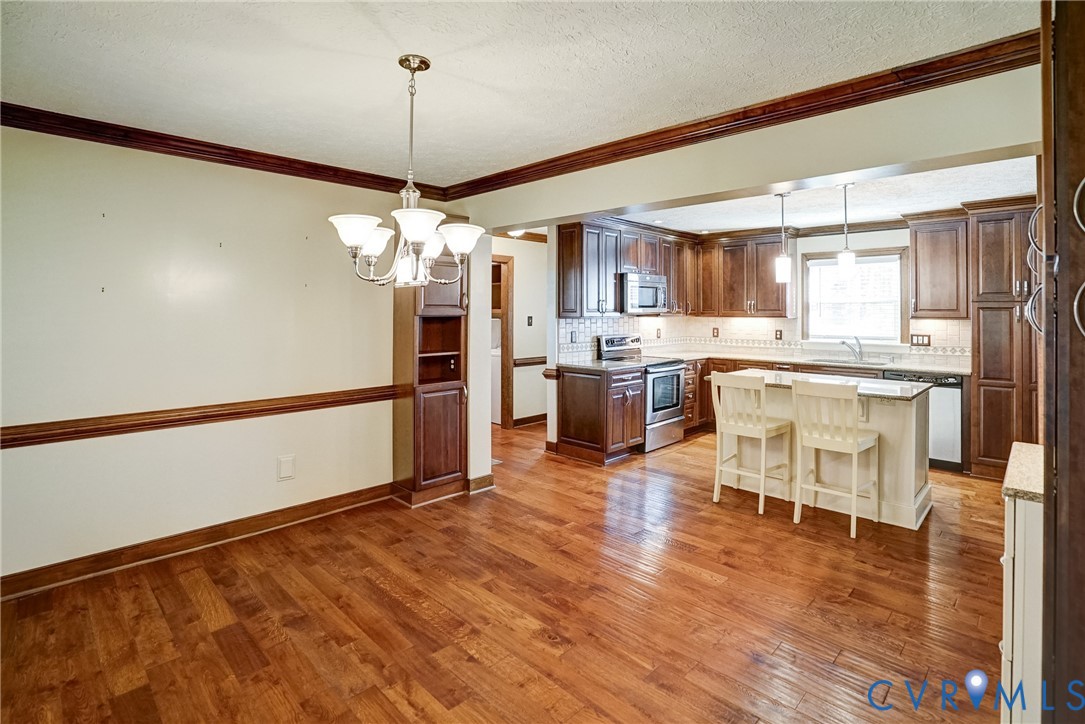 1253 Cardwell Road Crozier, VA 23039 - Photo 24 of 50 a living room with stainless steel appliances granite countertop furniture and a wooden floor