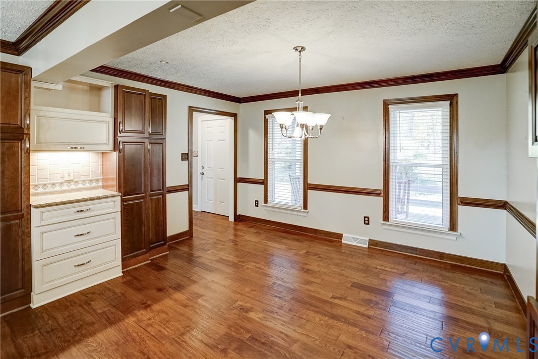 1253 Cardwell Road Crozier, VA 23039 - Photo 26 of 50 a view of an empty room with a window and wooden floor