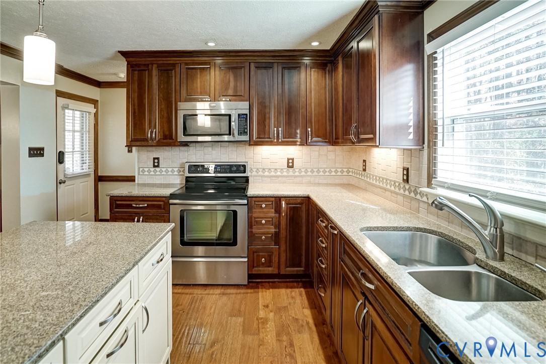 1253 Cardwell Road Crozier, VA 23039 - Photo 32 of 50 a kitchen with granite countertop a sink and steel appliances