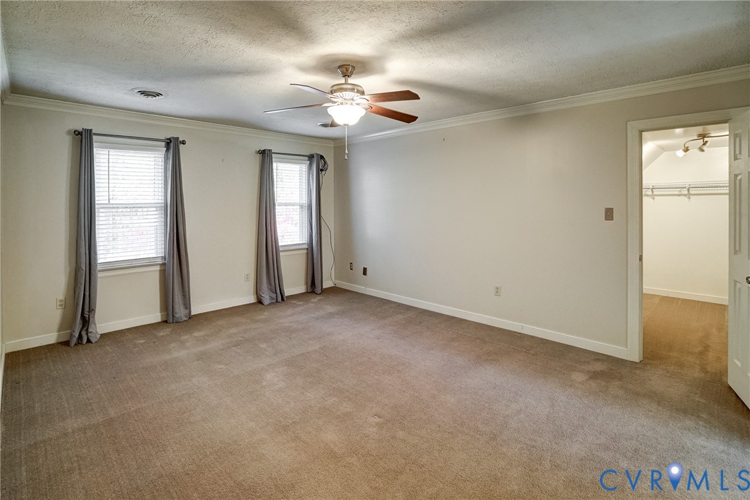 1253 Cardwell Road Crozier, VA 23039 - Photo 44 of 50 an empty room with chandelier fan and windows