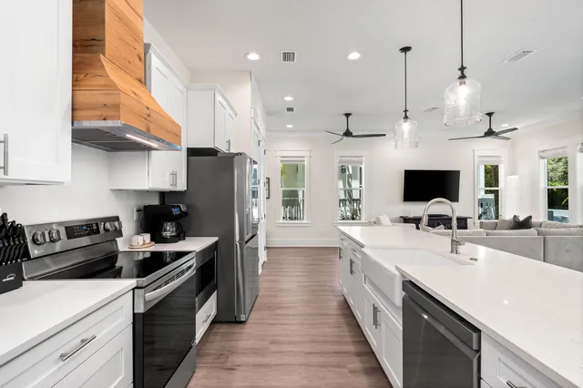 a view of kitchen with sink and wooden floor