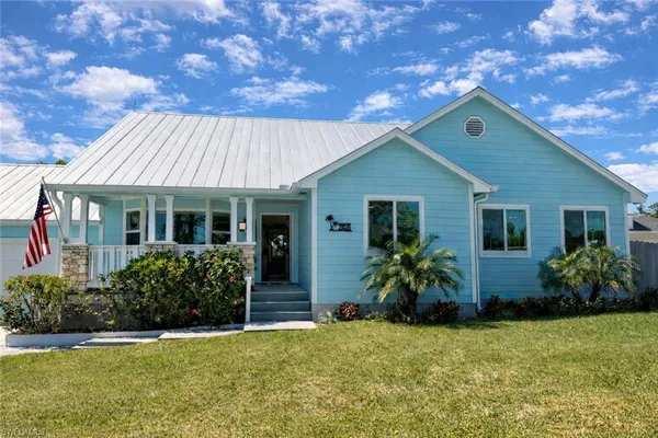 a front view of house with yard and outdoor seating