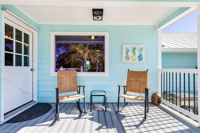 a living room with furniture a rug and a window