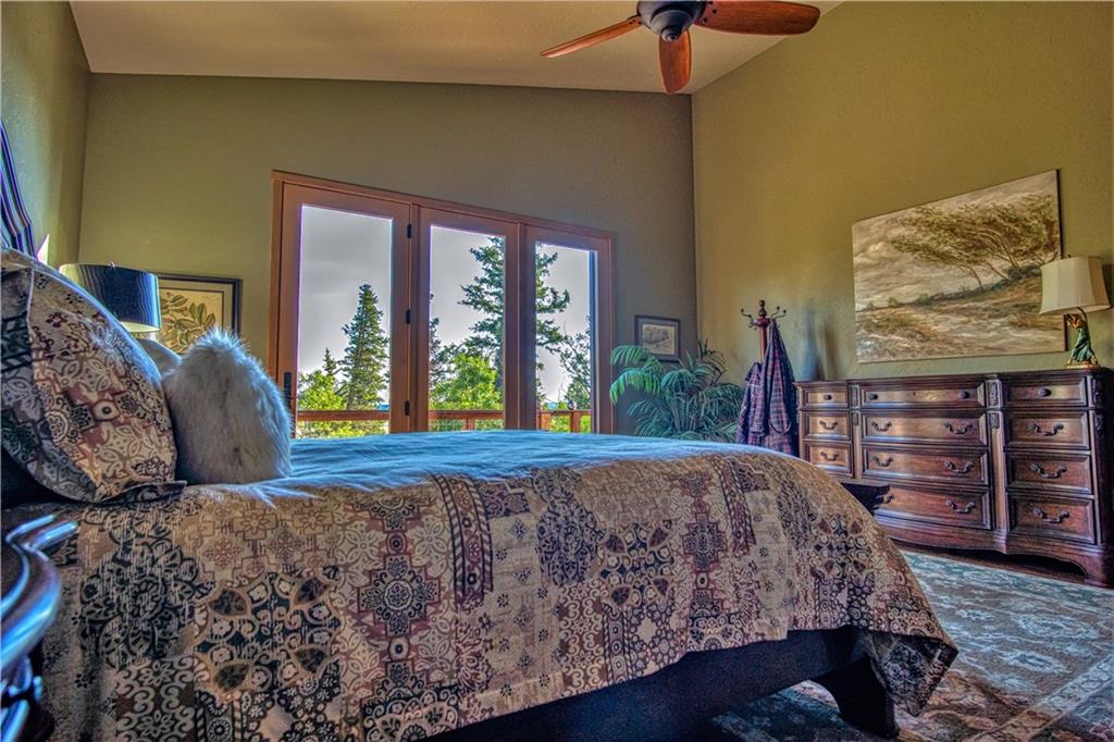813 Sheep Ridge Road Fairplay, CO 80440 - Photo 22 of 35 a bed sitting in a bedroom next to a window