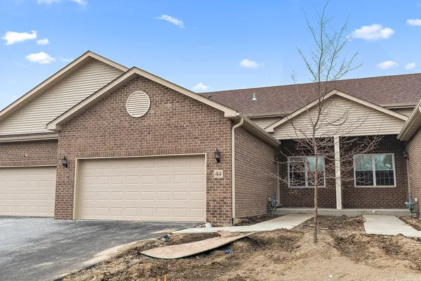 a front view of a house with garage