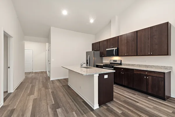 a kitchen with wooden floors and wooden cabinets