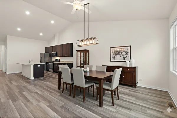 a view of a dining room with furniture wooden floor and chandelier