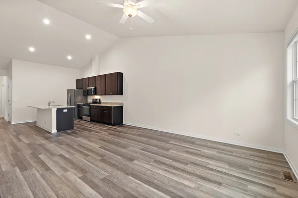 a view of kitchen with microwave and cabinets
