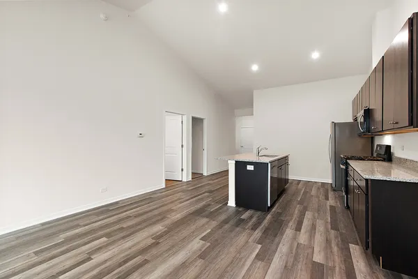 a view of a kitchen with wooden floor