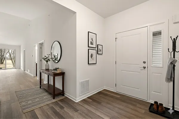 a view of a room with wooden floor mirror and a window
