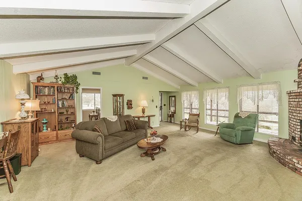 a living room with furniture and large windows