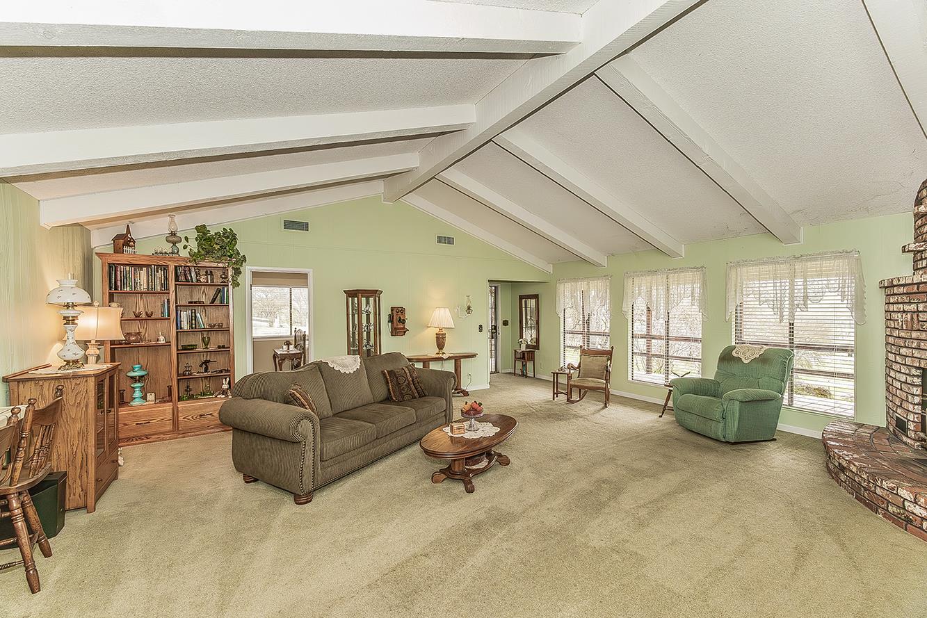 a living room with furniture and large windows