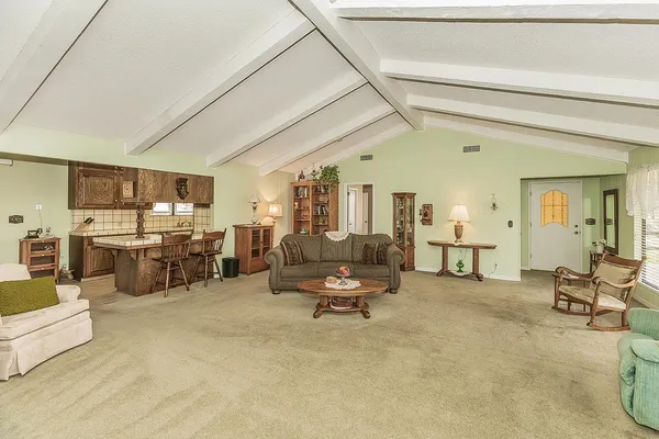 a living room with furniture and white cabinets