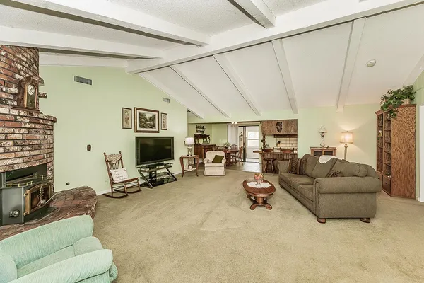 a living room with furniture gym equipment and a flat screen tv