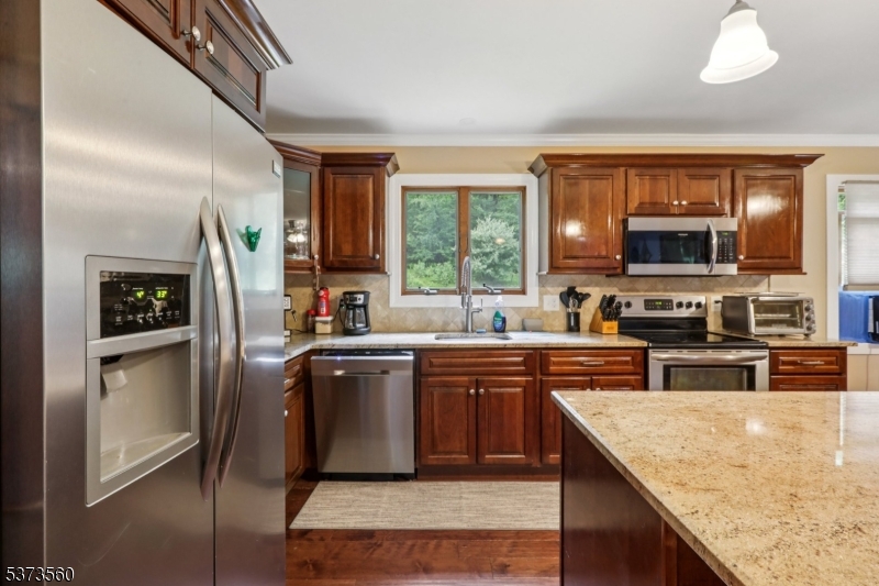 179 Mudtown Road Wantage, NJ 07461 - Photo 12 of 39 a kitchen with stainless steel appliances granite countertop a stove a sink a refrigerator and a microwave