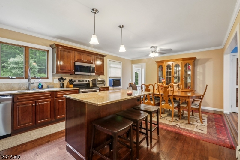 179 Mudtown Road Wantage, NJ 07461 - Photo 13 of 39 a large kitchen with a table and chairs