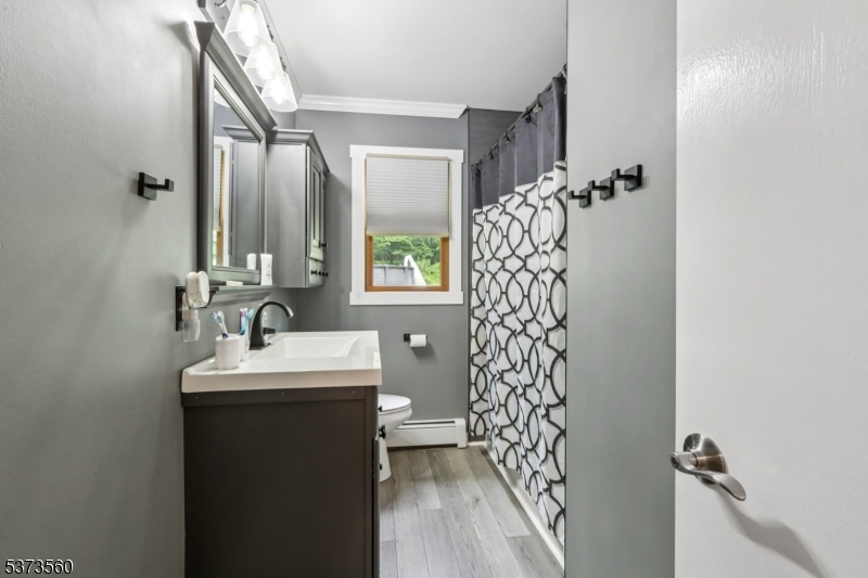 179 Mudtown Road Wantage, NJ 07461 - Photo 20 of 39 a bathroom with a sink a mirror a vanity and a shower