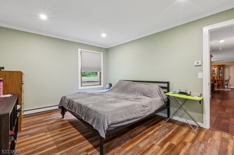 179 Mudtown Road Wantage, NJ 07461 - Photo 26 of 39 a bed sitting in a spacious bedroom next to a window and work place