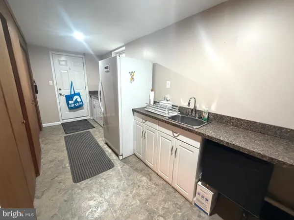 a kitchen with granite countertop a sink stove and cabinets