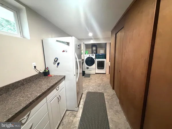 a view of a bathroom with mirror and sink