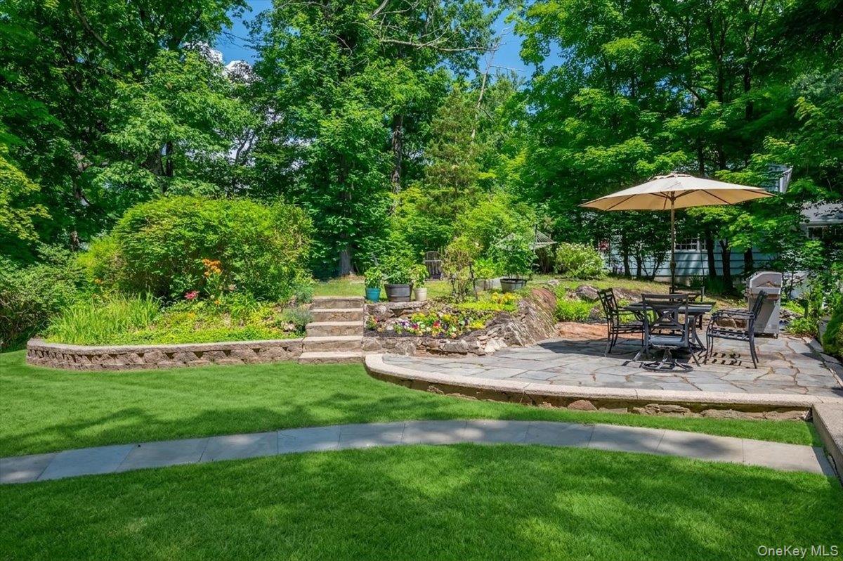 105 High St Extension Mount Kisco, NY 10549 - Photo 8 of 38 a view of a chair and table under an umbrella