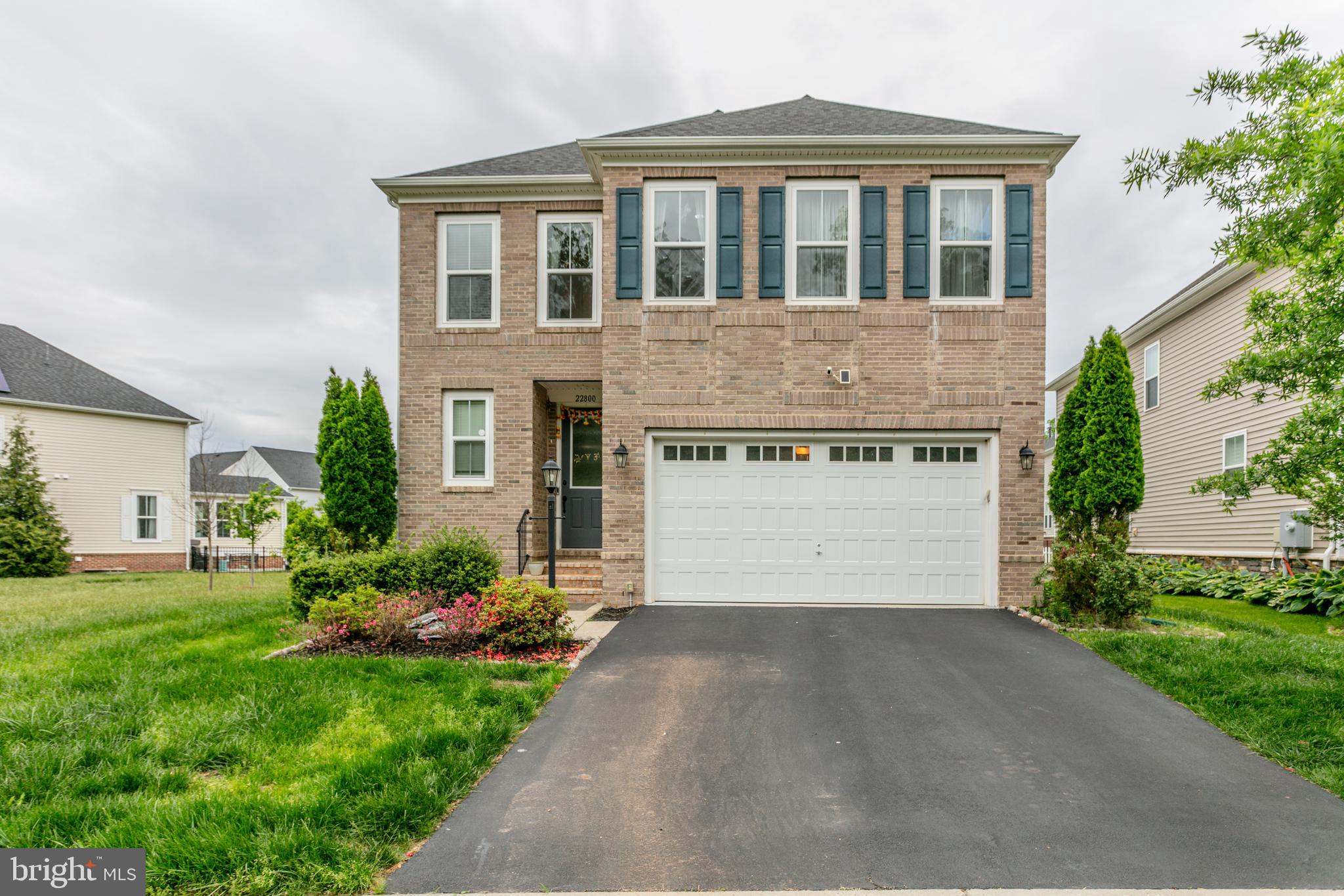 a front view of house with a garden