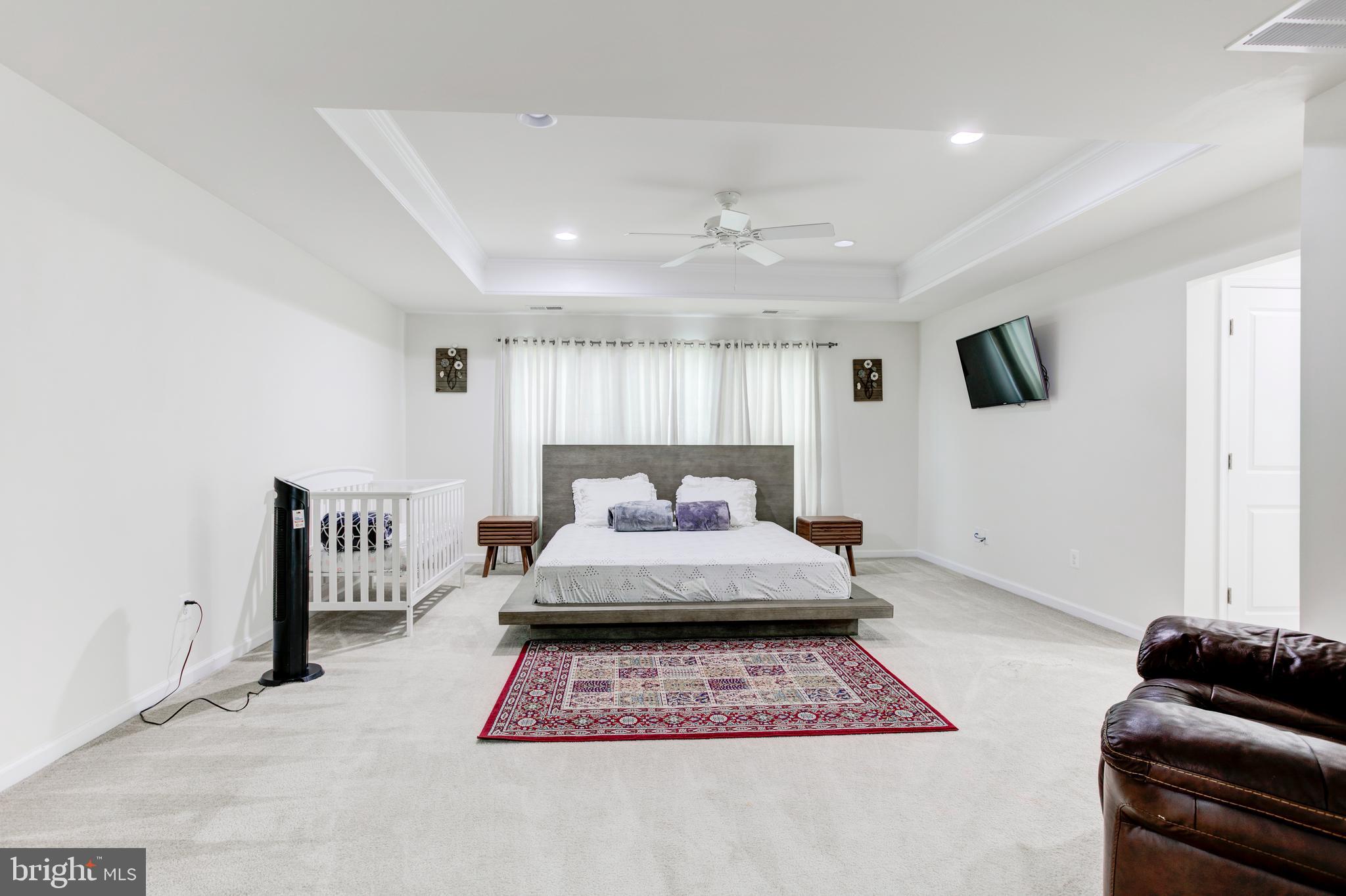 22800 Bubbling Brook Drive Brambleton, VA 20148 - Photo 30 of 64 a bedroom with a bed mirror and window