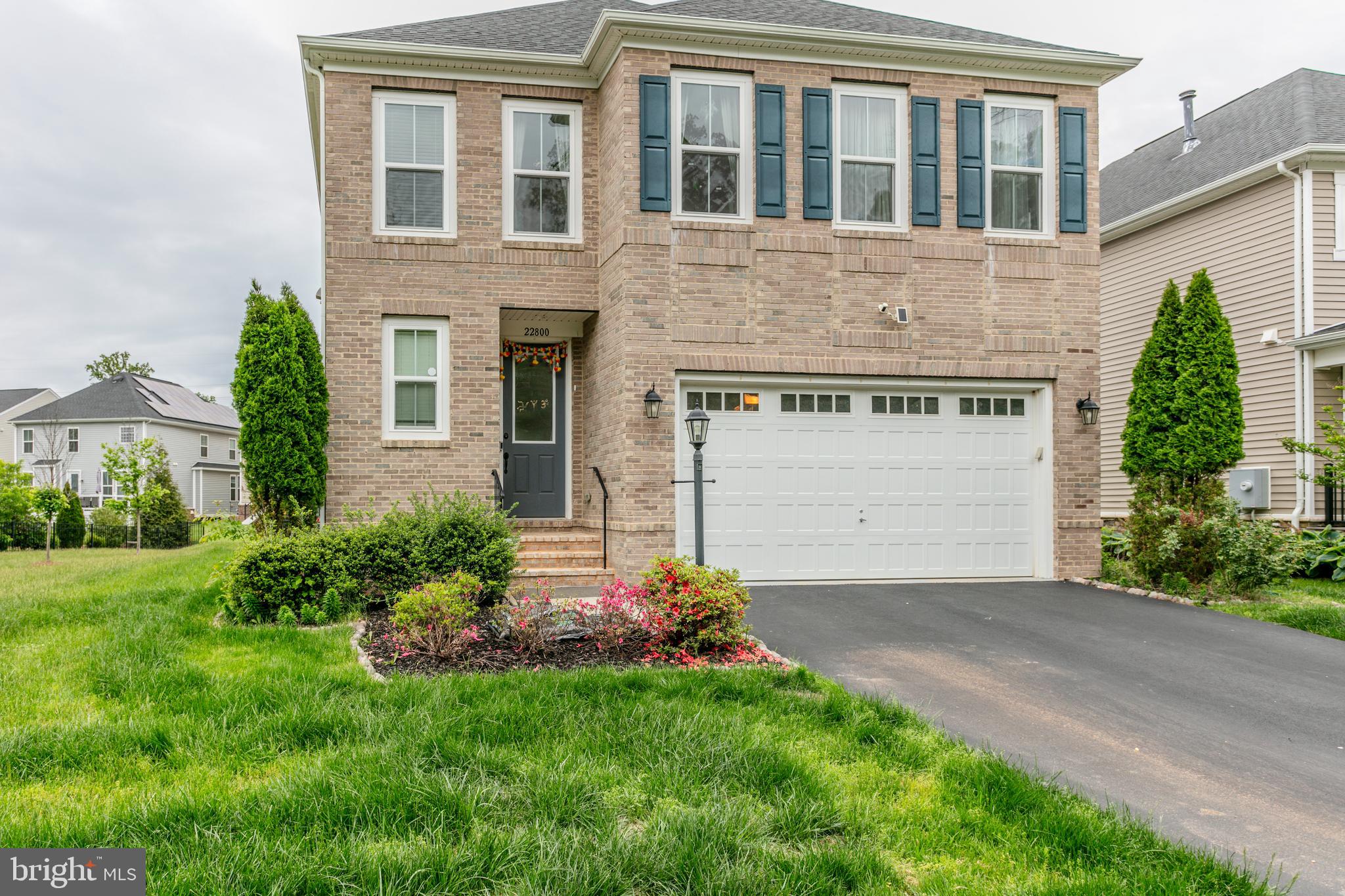 22800 Bubbling Brook Drive Brambleton, VA 20148 - Photo 3 of 64 a front view of a house with a garden