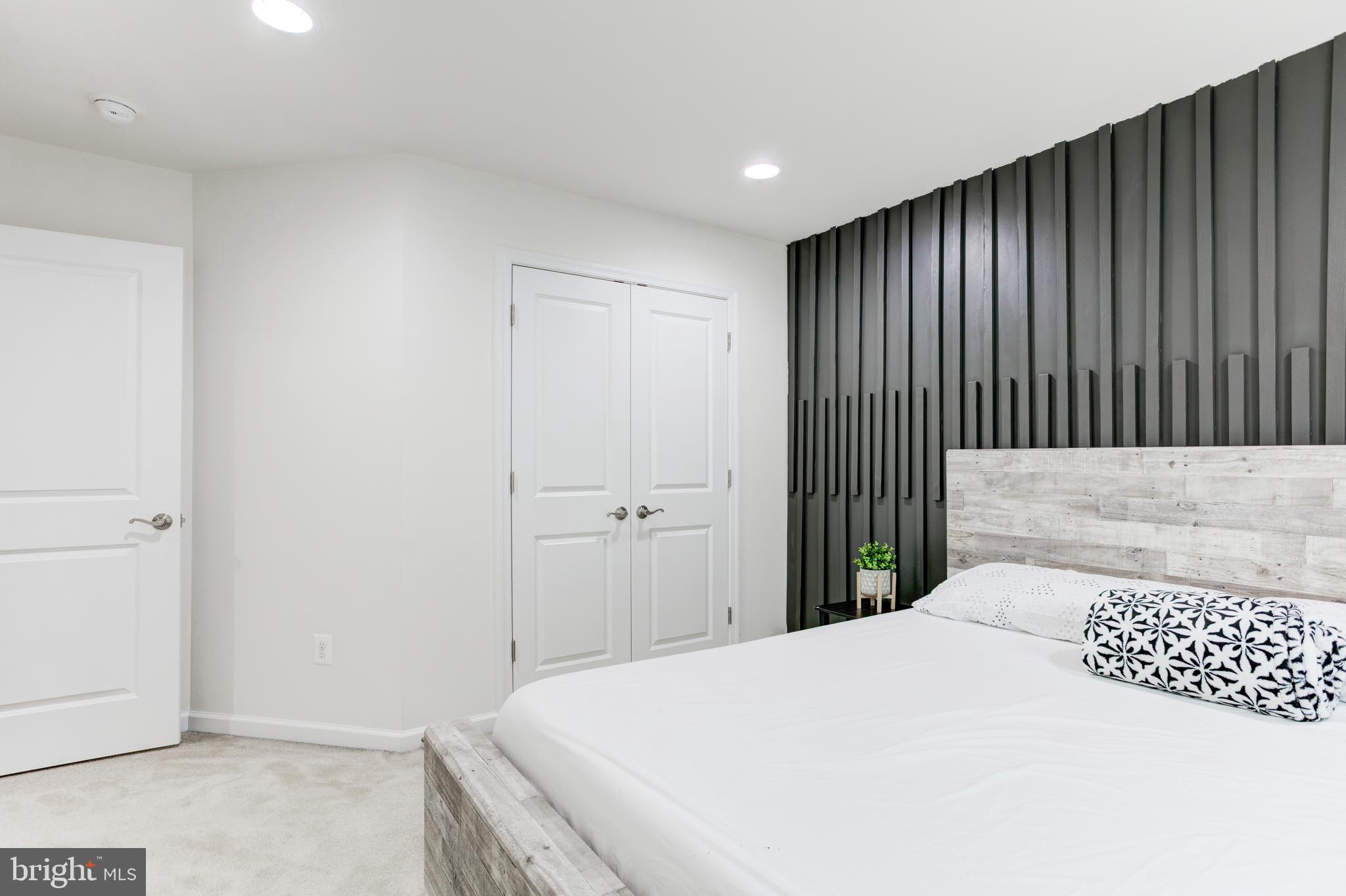 22800 Bubbling Brook Drive Brambleton, VA 20148 - Photo 39 of 64 a bedroom with a bed and a black walk in closet