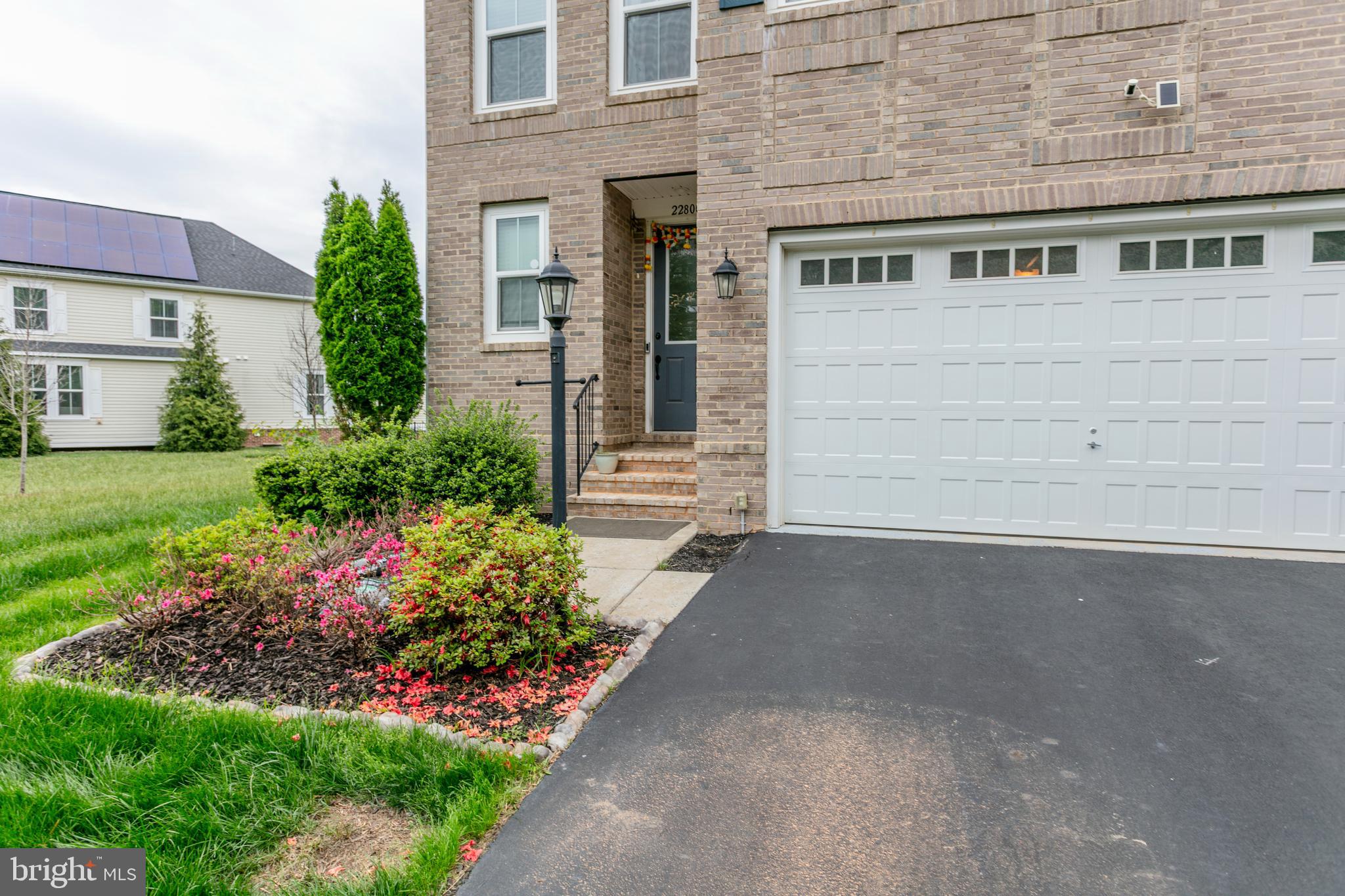 22800 Bubbling Brook Drive Brambleton, VA 20148 - Photo 4 of 64 front view of a house with a yard