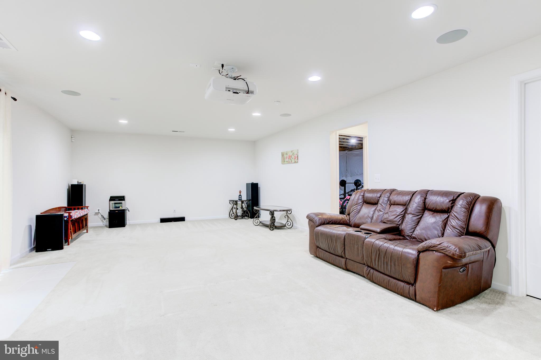 22800 Bubbling Brook Drive Brambleton, VA 20148 - Photo 51 of 64 a living room with furniture and a couch