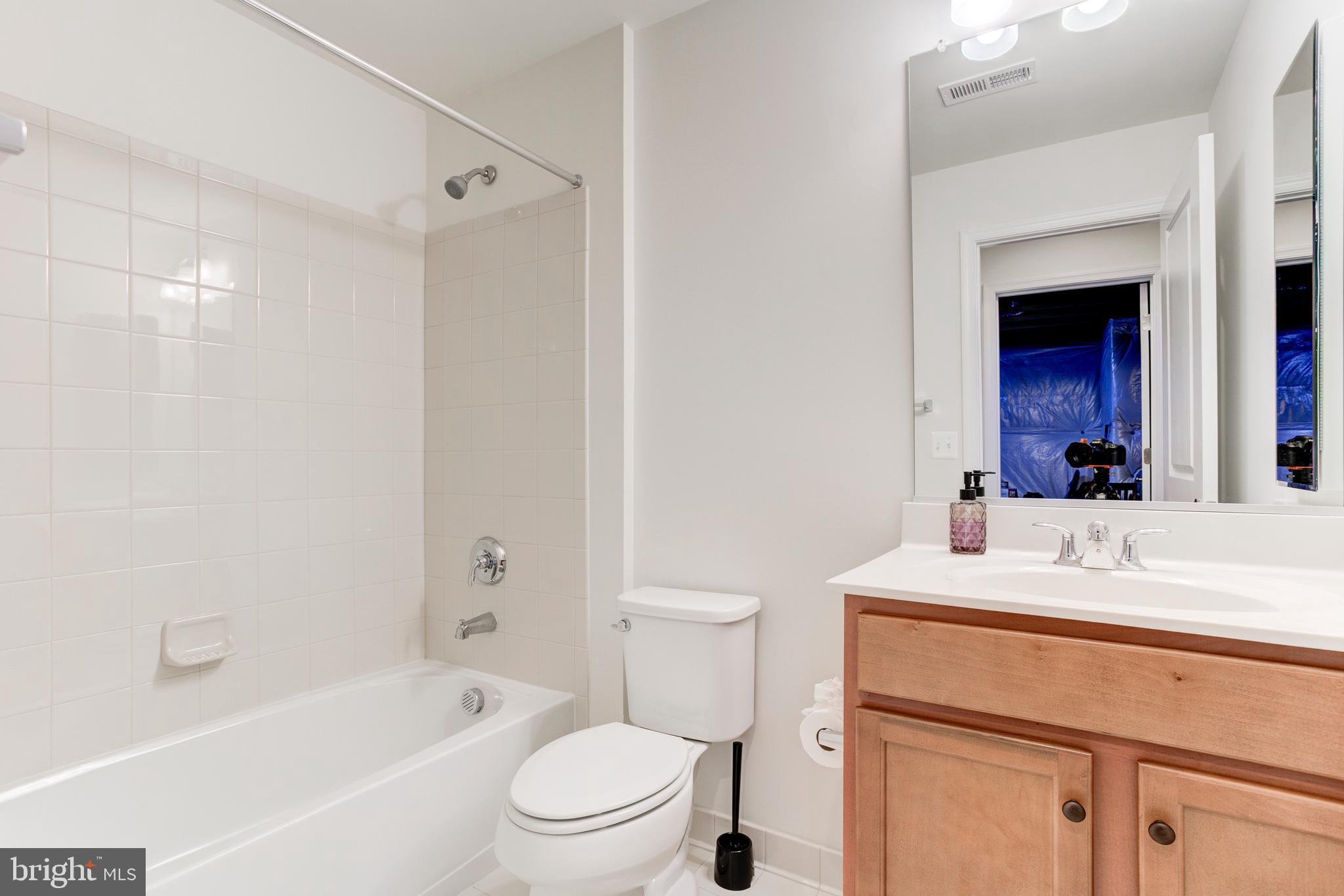 22800 Bubbling Brook Drive Brambleton, VA 20148 - Photo 55 of 64 a bathroom with a sink a toilet a mirror and shower