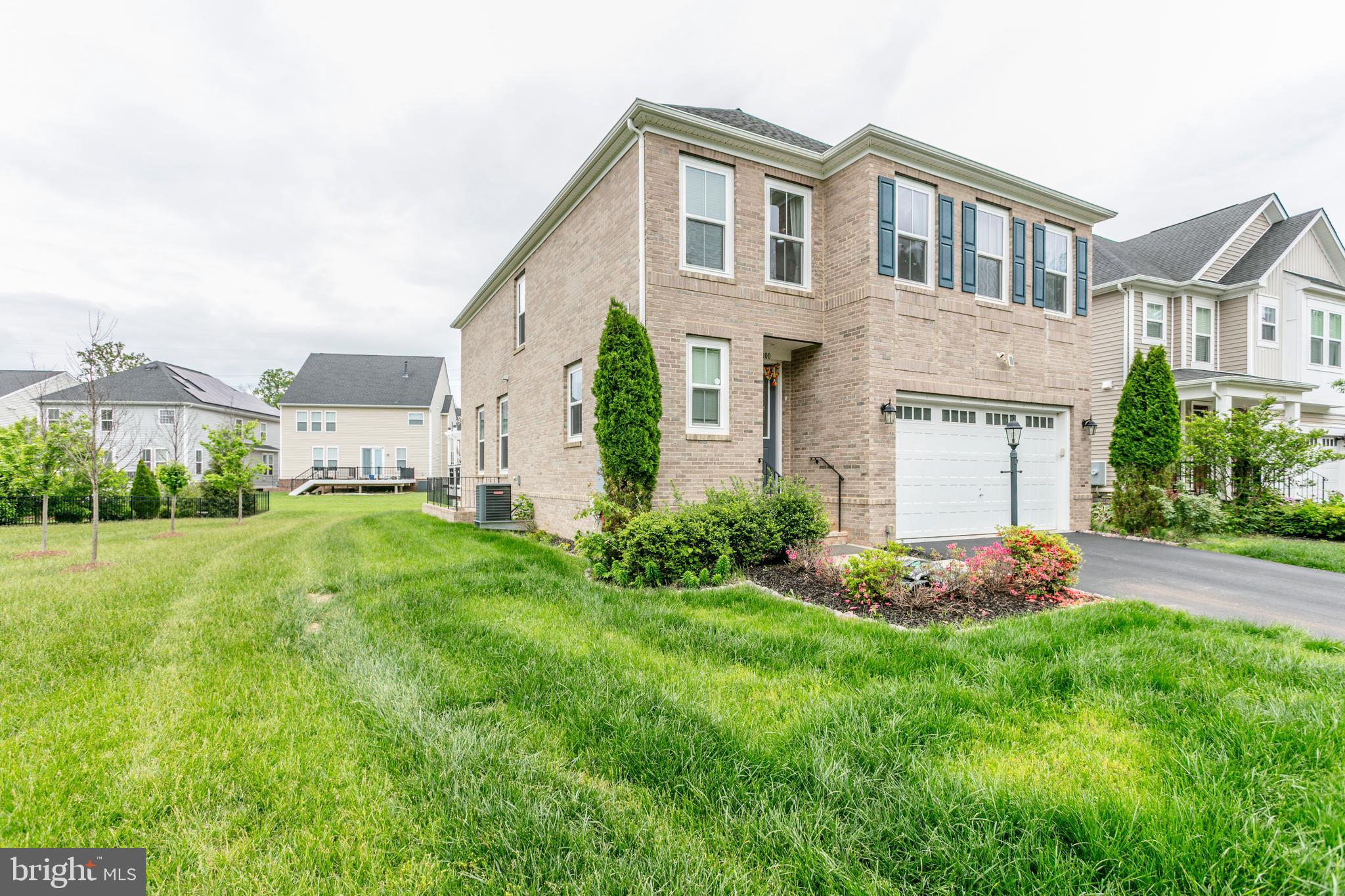 22800 Bubbling Brook Drive Brambleton, VA 20148 - Photo 56 of 64 a front view of a house with a yard and garage
