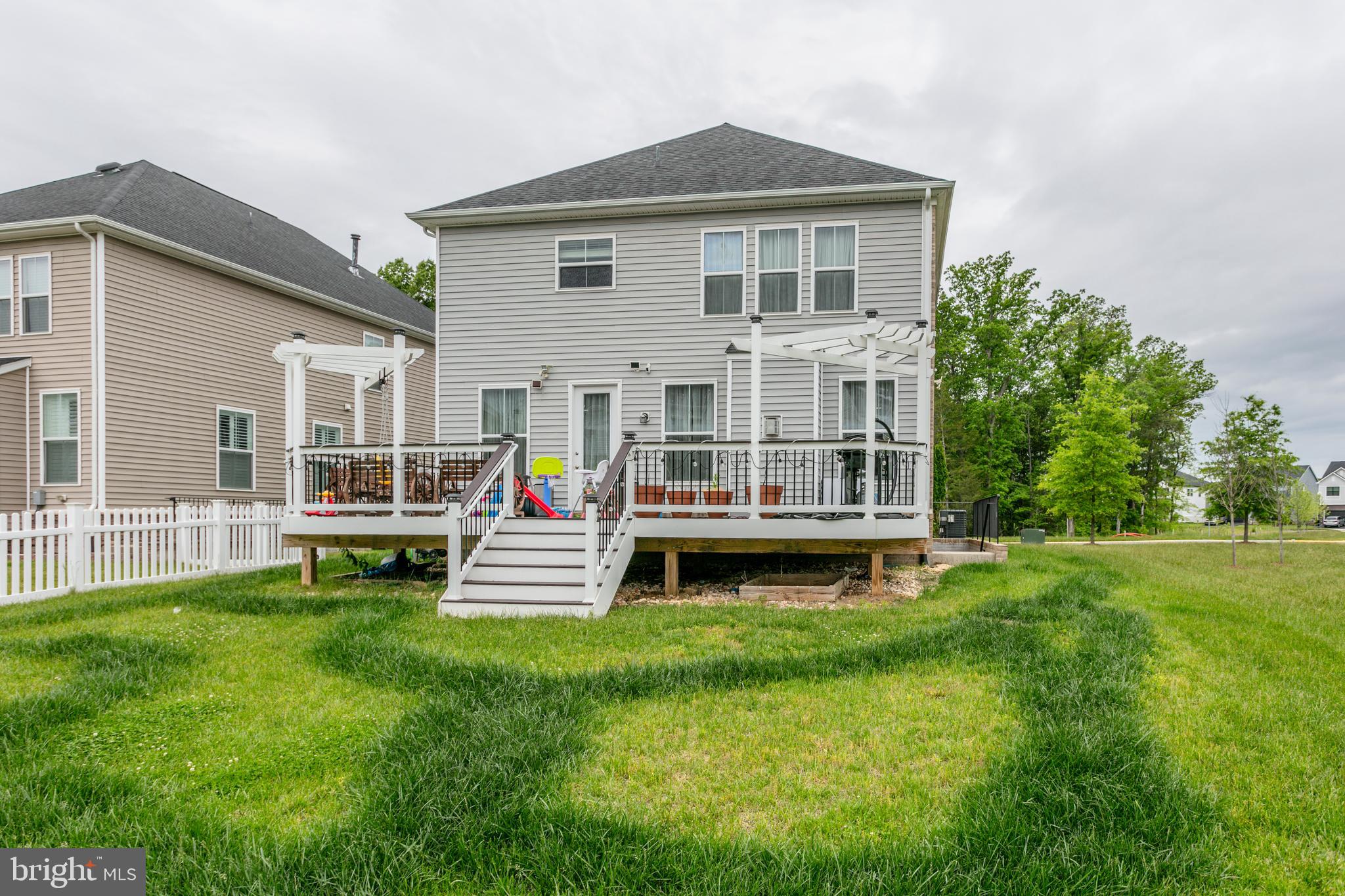 22800 Bubbling Brook Drive Brambleton, VA 20148 - Photo 60 of 64 a front view of house with a garden and patio