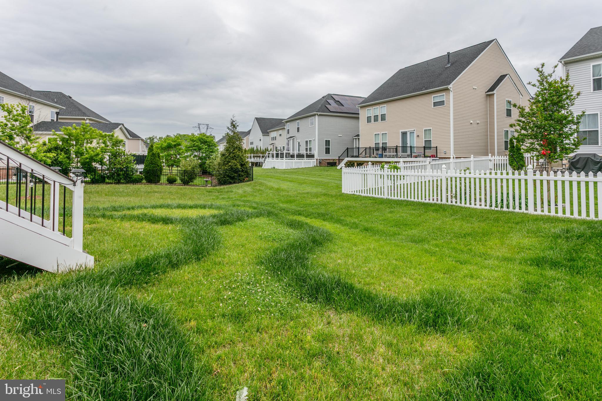 22800 Bubbling Brook Drive Brambleton, VA 20148 - Photo 61 of 64 a view of a house with a big yard and potted plants