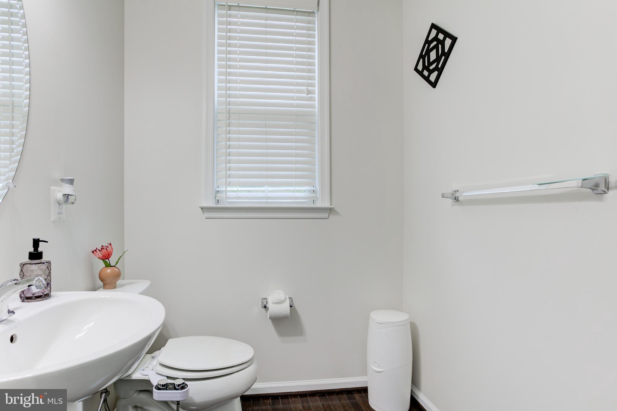 22800 Bubbling Brook Drive Brambleton, VA 20148 - Photo 7 of 64 a white toilet sitting next to a bathroom sink
