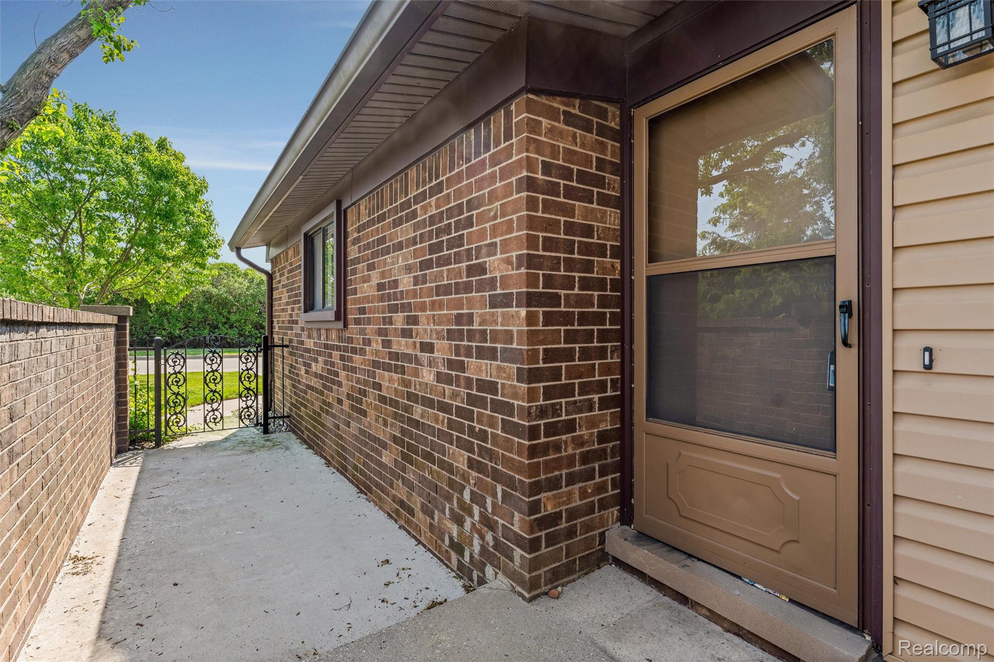 32105 West 12 Mile Road Farmington, MI 48334 - Photo 36 of 39 Doorway to property featuring brick siding and a gate