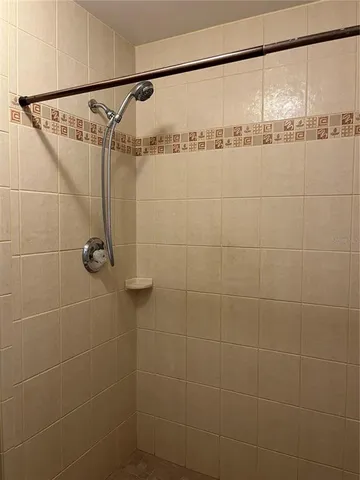 a bathroom with a shower and a shower