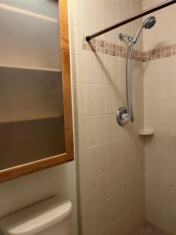 a bathroom with a shower and a shower