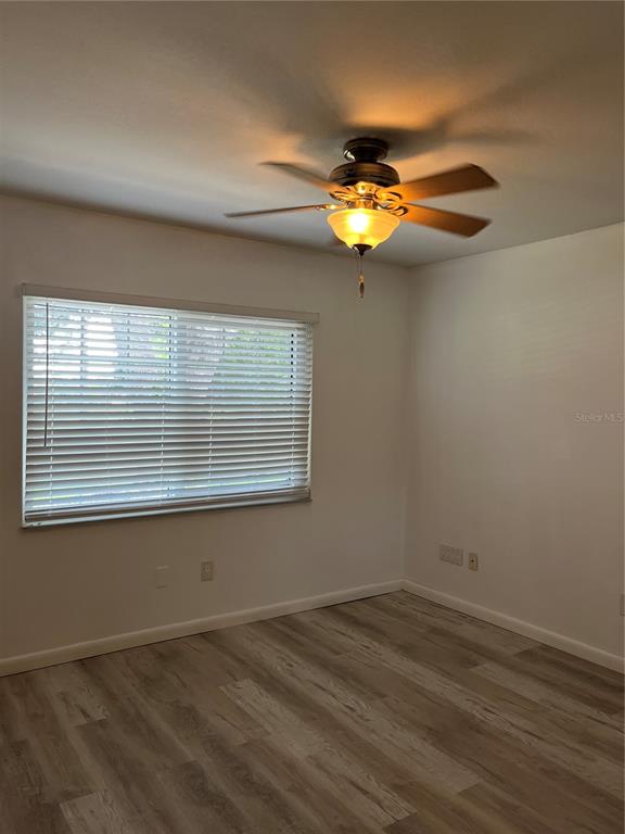 3160 Highlands Boulevard, Unit 3160 Palm Harbor, FL 34684 - Photo 17 of 40 a view of a room with wooden floor and a window
