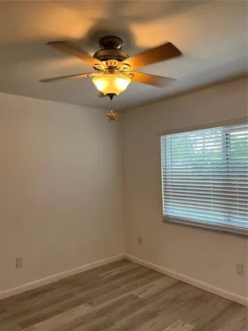 a view of a chandelier fan and wooden floor