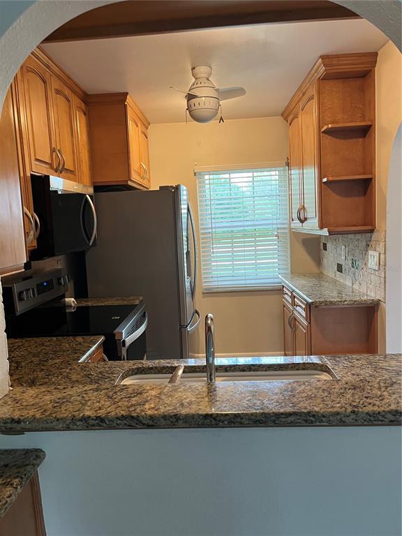 3160 Highlands Boulevard, Unit 3160 Palm Harbor, FL 34684 - Photo 2 of 40 a view of a kitchen with a sink and a window