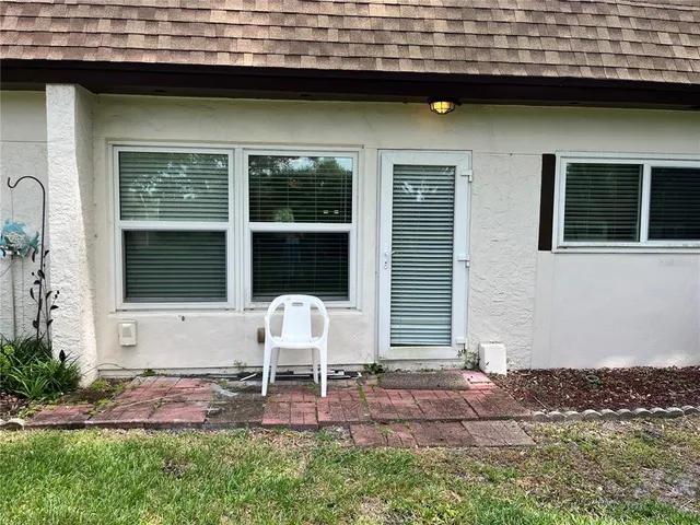 a view of house with backyard and porch