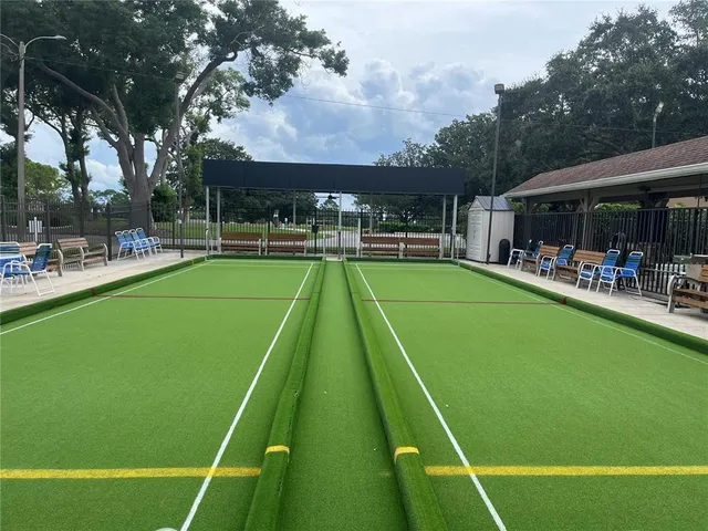 a view of a swimming pool with a patio and a yard